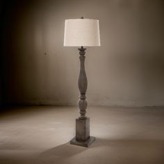 a lamp that is sitting in the middle of a room with a light on it