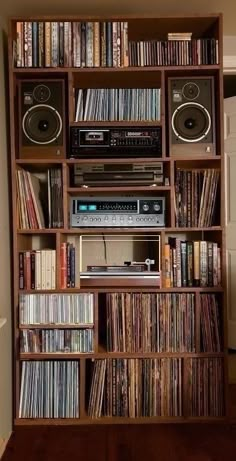 a bookshelf filled with lots of different types of audio equipment and music cassettes