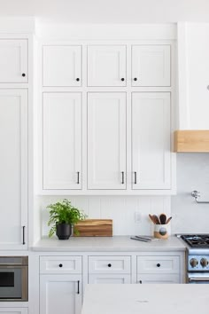 a kitchen with white cabinets and an oven