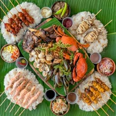 an overhead view of various food items on a green plate with rice and sauces