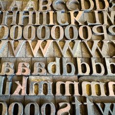 the letters are made out of wood blocks and have been placed together to form an intricate pattern