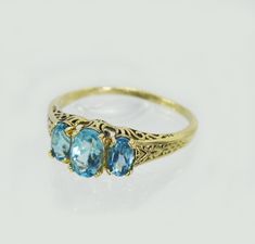 "14k yellow gold antique victorian ring , with 3 beautiful and real blue topaz gem stones . Hand made by myself Weight : about 1.9 gram Central stone : blue topaz 4/6 m\"m side stones : 2 blue topaz 3/5 m\"m" Elegant Yellow Gold Three-stone Topaz Ring, Antique 14k Gold Topaz Ring, Yellow Gold Three Stone Topaz Ring Fine Jewelry, Gold Topaz Three Stone Ring Fine Jewelry, Gold Three Stone Topaz Ring Fine Jewelry, Heirloom Blue Topaz Ring, Antique Blue Topaz Round Ring, Antique Topaz Promise Ring, Classic Three Stone Blue Topaz Ring