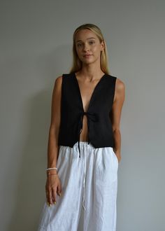 Our relaxed-fit linen vest with a front tie is the perfect piece for summer days. Made from 100% OEKO-TEX certified linen, it's both comfortable and breathable. This versatile vest looks great with jeans, shorts, or pants--really, it complements any outfit. If you're after a romantic yet stylish look this summer, this vest is just what you need. DETAILS: - Front Tie (We can add second tie for better support upon request) - V neck  - Relaxed Fit  - Customization available: We can shorten the fron Casual Linen Beach Vest, Linen Vest For Daywear, Linen Tie Waist Top For Summer, Summer Linen Tops With Tie Waist, Summer Linen Top With Tie Waist, Beach Linen Tops With Tie Waist, Spring Linen Beach Vest, Casual Linen Tank Top For Daywear, Casual Linen Tops With Tie Straps