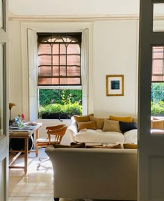 a living room filled with furniture and windows