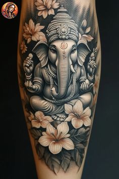 an elephant tattoo with flowers on it