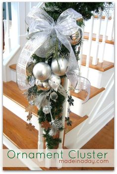 an ornament clusterer on the banister is adorned with silver and white ornaments