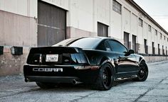 a black car parked in front of a building