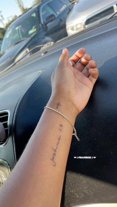 a woman's hand on the door handle of a car with her name written on it