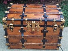 an old fashioned wooden trunk sitting on the sidewalk