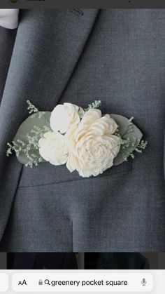 a man wearing a suit and tie with flowers on the lapel flower is shown