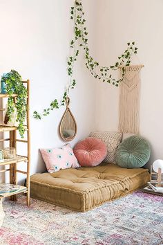 a living room filled with lots of furniture and plants on top of the wall next to a rug