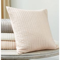 the pillows are stacked on top of each other