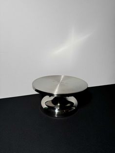 a black table with a silver plate on it