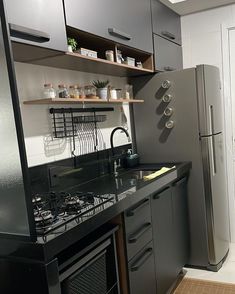 a kitchen with black counter tops and stainless steel appliances