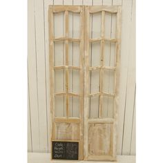 an old window with a chalkboard attached to the front and side panels that have been stained white