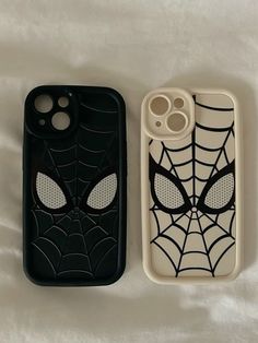 two cell phones with spider - man faces on them, one is black and the other is white