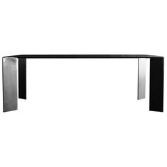 a black and white photo of a table with two legs on each side, in front of a white background