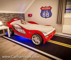 a child's bedroom with a red car bed