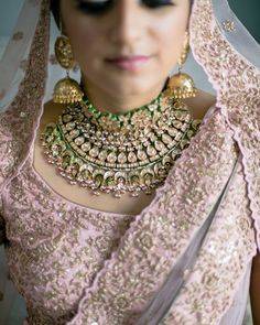 a woman in a wedding outfit with jewelry on her neck