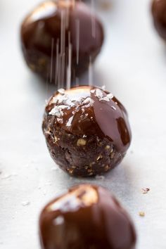 chocolate covered doughnuts with sprinkles on the top are lined up and ready to be eaten