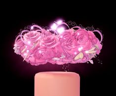 there is a pink cake with flowers on it and lights in the top tiers