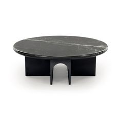 an oval table with black legs and a marble top, on a white background in the style of art deco