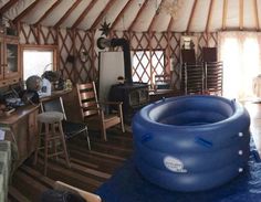 an inflatable mattress is placed on the floor next to a table and chairs