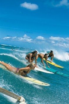 several people on surfboards riding waves in the ocean