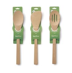 three wooden utensils with spoons and forks attached to the handles, one in green packaging