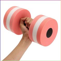 a hand holding two pink and white dumbbells in front of a white background