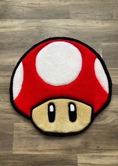 a mushroom rug is on the floor in front of a wooden floor with wood floors