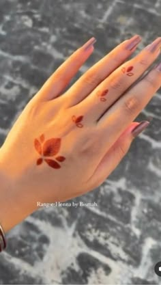 a woman's hand with flowers painted on it