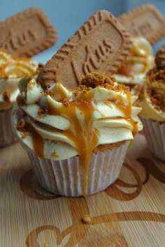 several cupcakes with white frosting and caramel drizzle