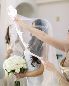 the bride is getting ready to walk down the aisle in her wedding dress and veil