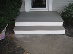 two steps leading to the front door of a house