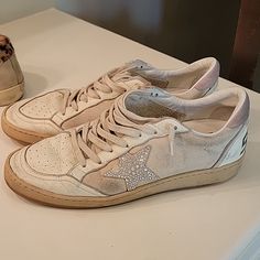 Dreaming Of The Eighties. This Ball Star Sneaker Has An American College Vibe Featuring White Nappa Leather, A Swarovski Crystal Star, Pink Suede Heel Tab And Cream Laces. These Are Well Loved And Used! Golden Goose Ball Star, Pink Suede Heels, The Eighties, Golden Goose Shoes, Crystal Stars, Star Sneakers, Pink Suede, Cream Lace, Golden Goose