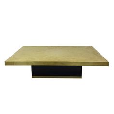 a gold and black coffee table on a white background with no one around the table