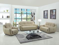 a living room filled with furniture next to a large glass table and wall mounted pictures