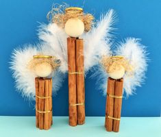 three wooden sticks with white feathers on them