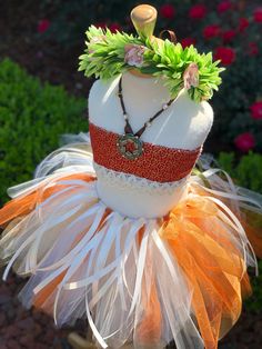 a mannequin with an orange and white dress on it