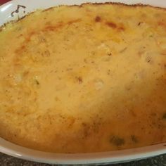 a casserole dish with cheese and broccoli in it