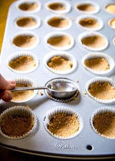 a person is spooning some food into a muffin tin filled with cupcake batter