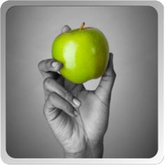 a person holding an apple in their hand