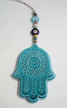 a blue hamsa hanging from a string