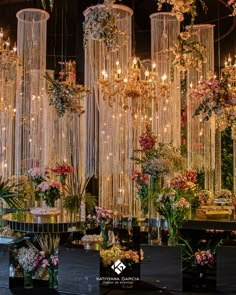 a room filled with lots of flowers and chandeliers