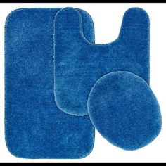 two blue bathroom rugs with one on the left and one on the right side