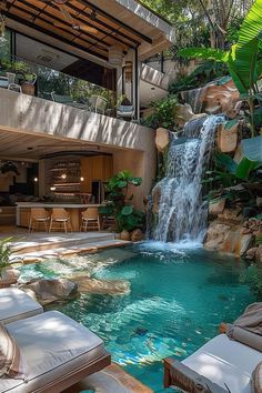 an outdoor swimming pool with waterfall and lounge chairs next to it in front of a house