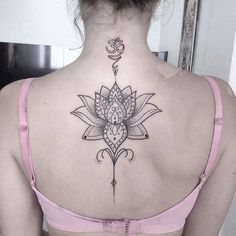 a woman with a lotus tattoo on her back