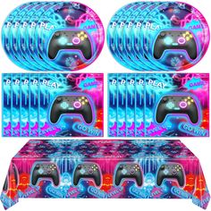 four video game controllers with different designs on them, all in bright blue and pink