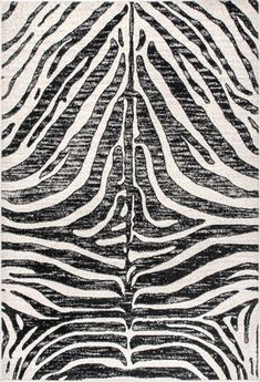 a black and white zebra print with lines in the center, on top of an area rug